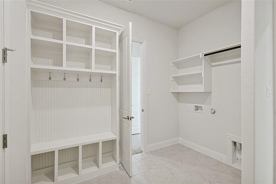 Mudroom with light tile patterned floors