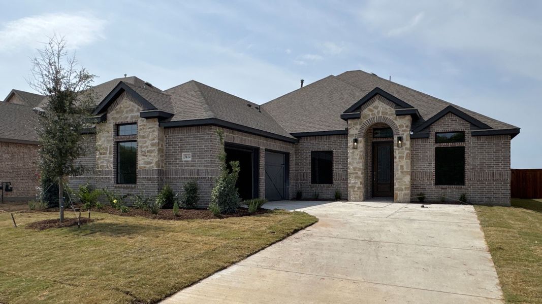 Front exterior of a new home in Peachtree Meadows, Rockwall, TX, highlighting curb appeal (Image 1). Front exterior of a new home in Peachtree Meadows, Rockwall, TX, highlighting curb appeal (Image 1).