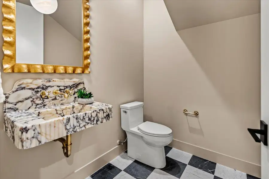 Powder room with custom marble vanity.