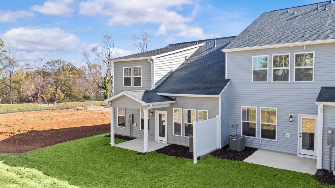 Vibrant rear outdoor space featuring a covered porch and exceptional craftsmanship