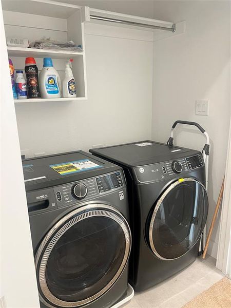 Laundry area featuring independent washer and dryer and tile patterned floors