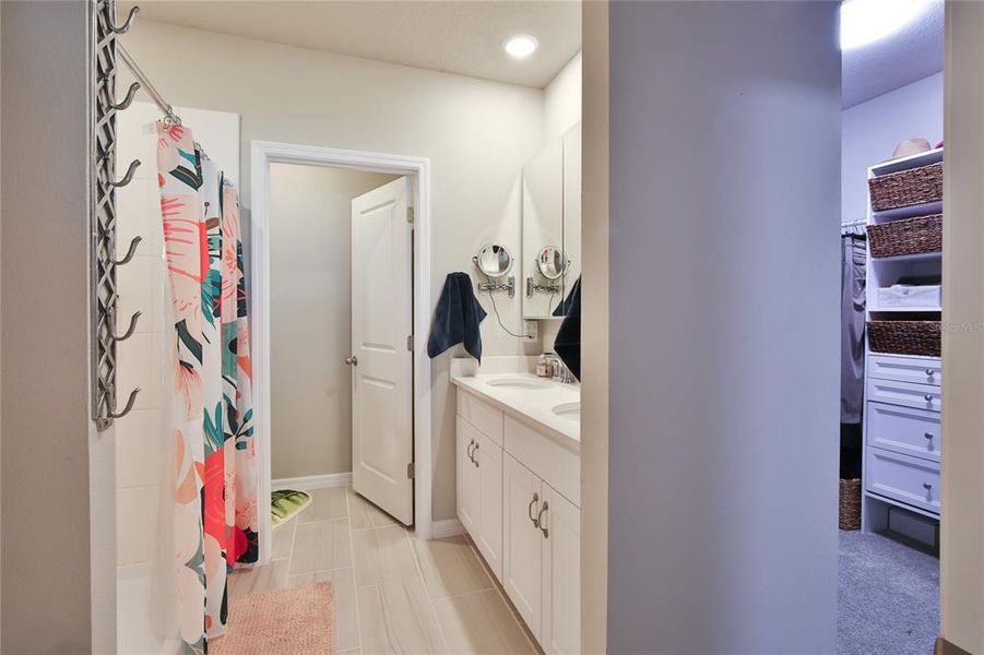 Toilet Room, Dual Sinks & Well Appointed Primary Walk in Closet w/Custom Closet Organizer