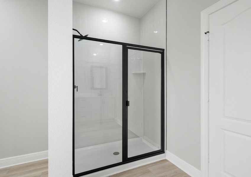 The master bath has a spacious, glass-enclosed shower.