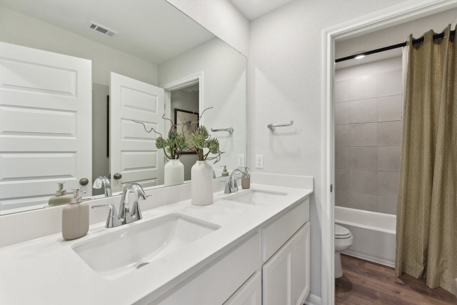 A bathroom with a sink toilet and a bathtub. A bathroom with a sink toilet and a bathtub.