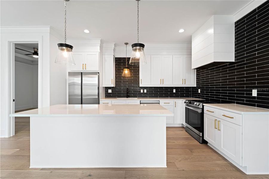 Chefs Kitchen with Island and Pendant Lighting