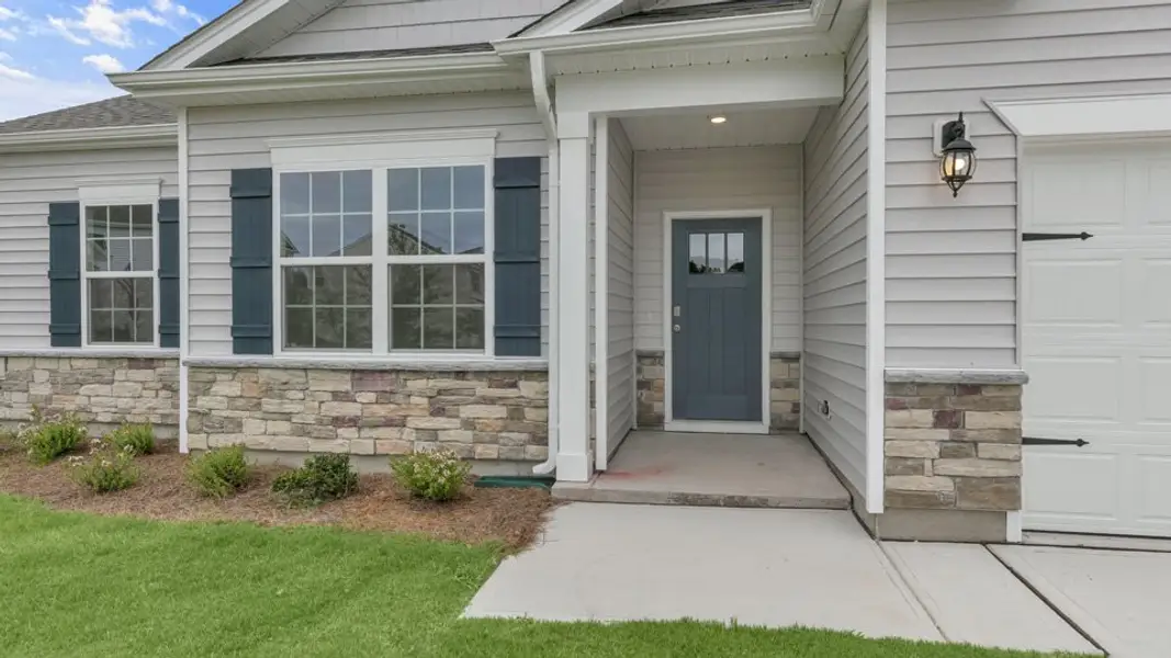 Exterior details and patio area of a home in Cross Creek, Spring Lake (Image 3).