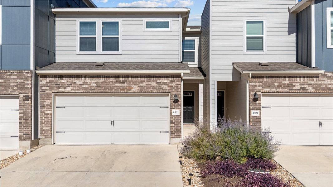 View of front of house featuring brick siding, driveway, a garage, and roof with shingles View of front of house featuring brick siding, driveway, a garage, and roof with shingles
