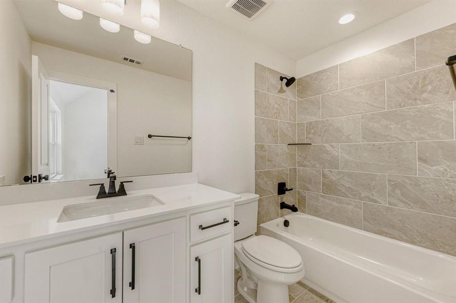 Full bath featuring shower / bath combination, vanity, recessed lighting, and light tile patterned floors