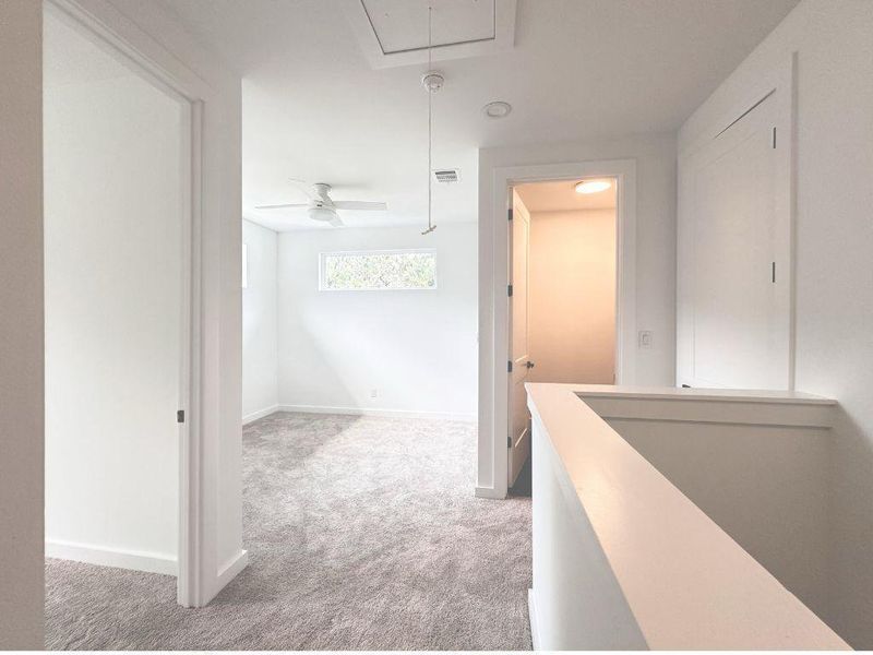 A quiet upper level features a cozy bedroom with ample natural light and a soft carpeted floor. A quiet upper level features a cozy bedroom with ample natural light and a soft carpeted floor.