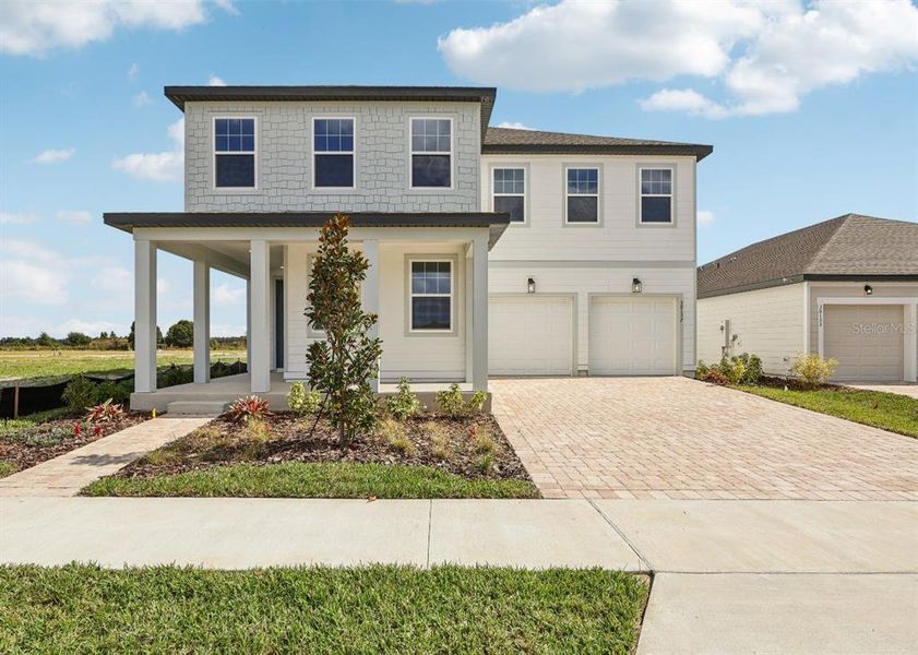 Front exterior of a new home in Trailside, Mount Dora, FL, highlighting curb appeal (Image 20).