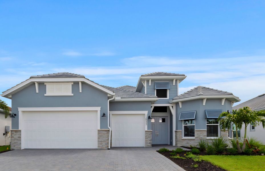 Front exterior of a new home in TerraWalk at Babcock Ranch, Alva, FL, highlighting curb appeal (Image 1). Front exterior of a new home in TerraWalk at Babcock Ranch, Alva, FL, highlighting curb appeal (Image 1).