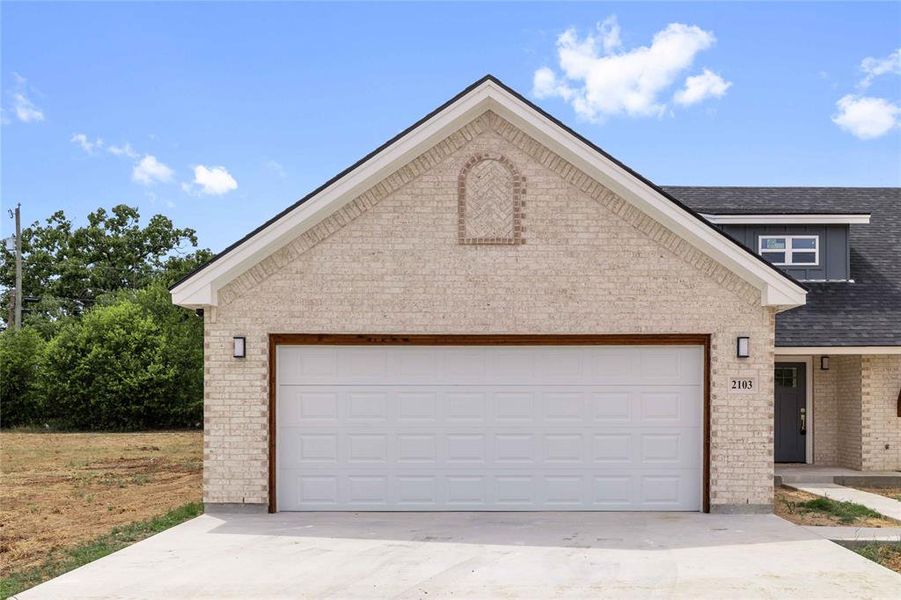 View of front of house with brick siding, roof with shingles, driveway, and an attached garage View of front of house with brick siding, roof with shingles, driveway, and an attached garage
