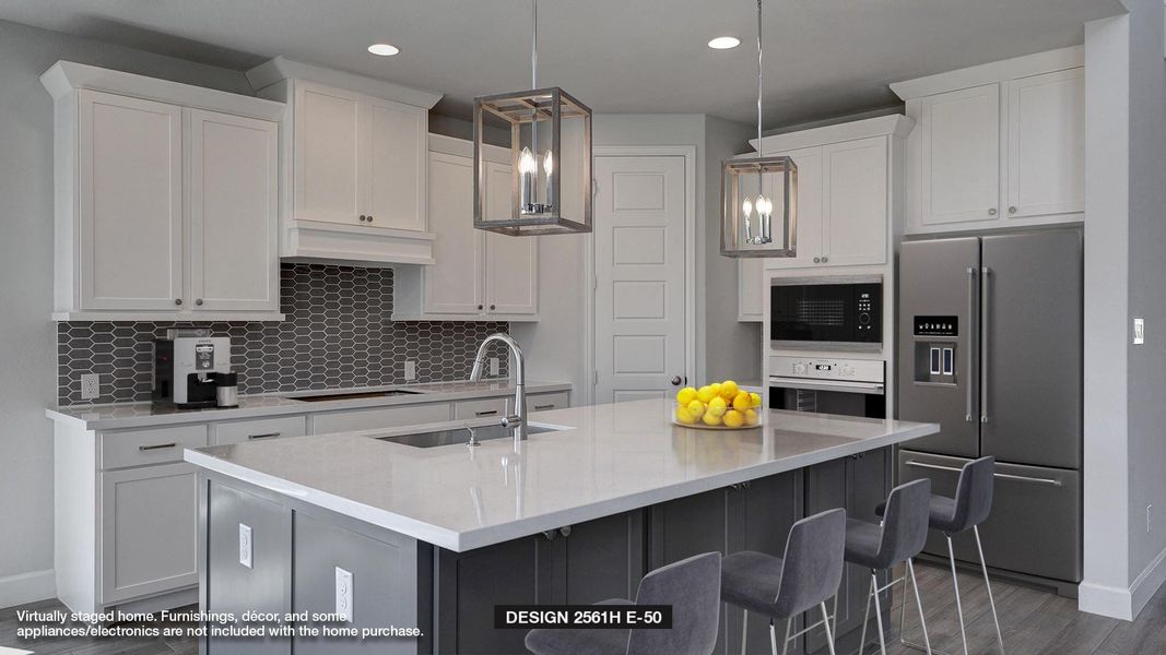 Kitchen with pendant lighting, sink, a kitchen island with sink, stainless steel appliances, and white cabinets