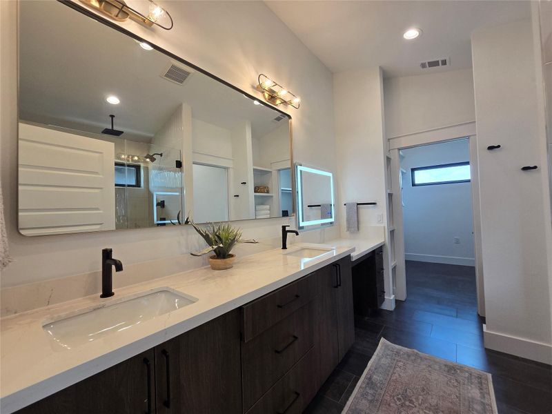 Primary bath with dual vanities, and a separate makeup desk area.