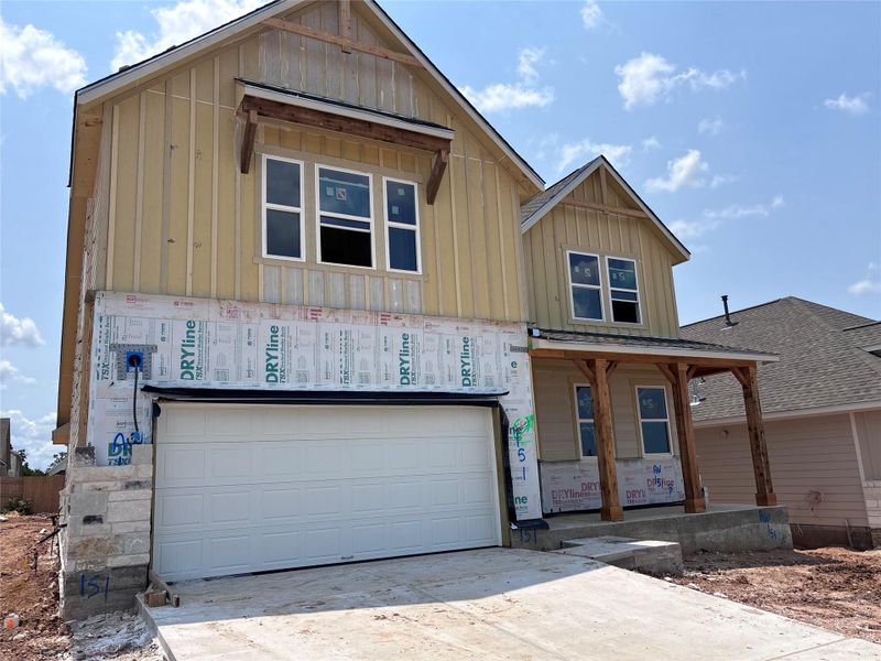 Front exterior of a new home in The Colony 50s, Bastrop, TX, highlighting curb appeal (Image 9). Front exterior of a new home in The Colony 50s, Bastrop, TX, highlighting curb appeal (Image 9).