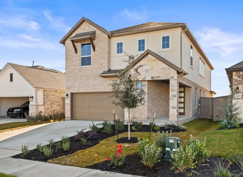 Front exterior of a new home in Flora, Hutto, TX, highlighting curb appeal (Image 22).
