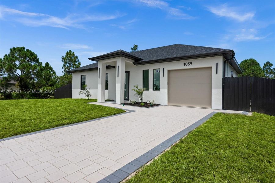 Front exterior of a new home in , Lehigh Acres, FL, highlighting curb appeal (Image 2). Front exterior of a new home in , Lehigh Acres, FL, highlighting curb appeal (Image 2).