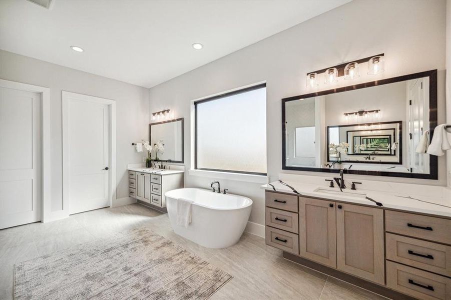 Floating cabinets and framed mirrors are just some of the custom finishes in this bathroom.