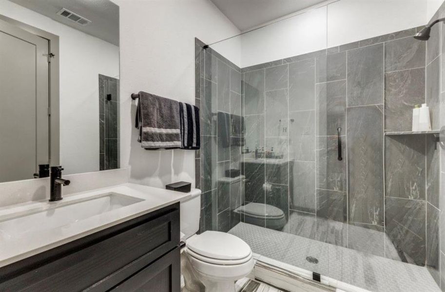 Full bath with a marble finish shower and vanity Full bath with a marble finish shower and vanity