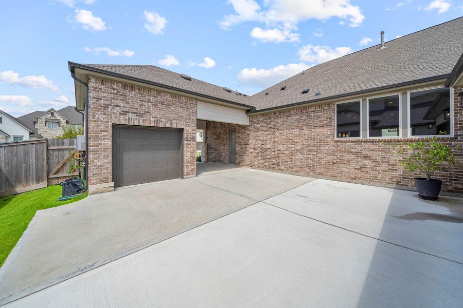 Front exterior of a new home in Bridgeland 80′, Cypress, TX, highlighting curb appeal (Image 26). Front exterior of a new home in Bridgeland 80′, Cypress, TX, highlighting curb appeal (Image 26).