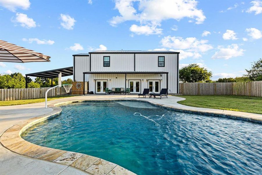Rear view of house featuring french doors, a patio area, and a fenced backyard Rear view of house featuring french doors, a patio area, and a fenced backyard