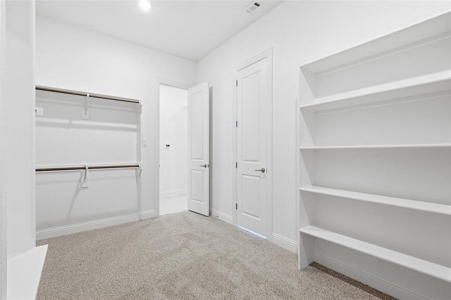 Walk in closet with light colored carpet Walk in closet with light colored carpet