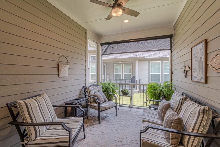 Sunroom / solarium with a ceiling fan and plenty of natural light