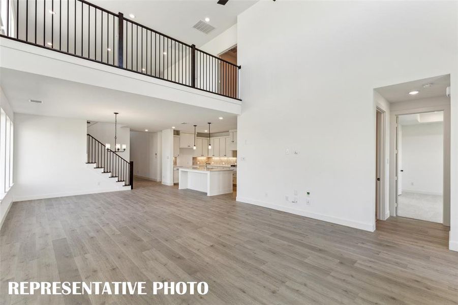Featuring an open metal railing in the game room that overlooks the family room, you'll enjoy a dual level entertainment zone in this lovely home!  REPRESENTATIVE PHOTO