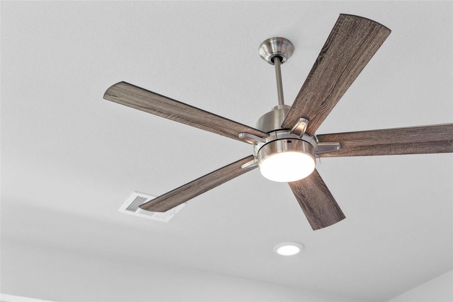 A striking, contemporary ceiling fan anchors the room, perfectly balancing modern engineering with sophisticated style. A striking, contemporary ceiling fan anchors the room, perfectly balancing modern engineering with sophisticated style.