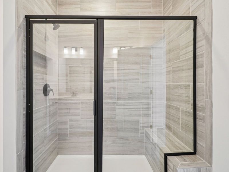 The primary bathroom offers dual vanity sinks and a walk-in shower.