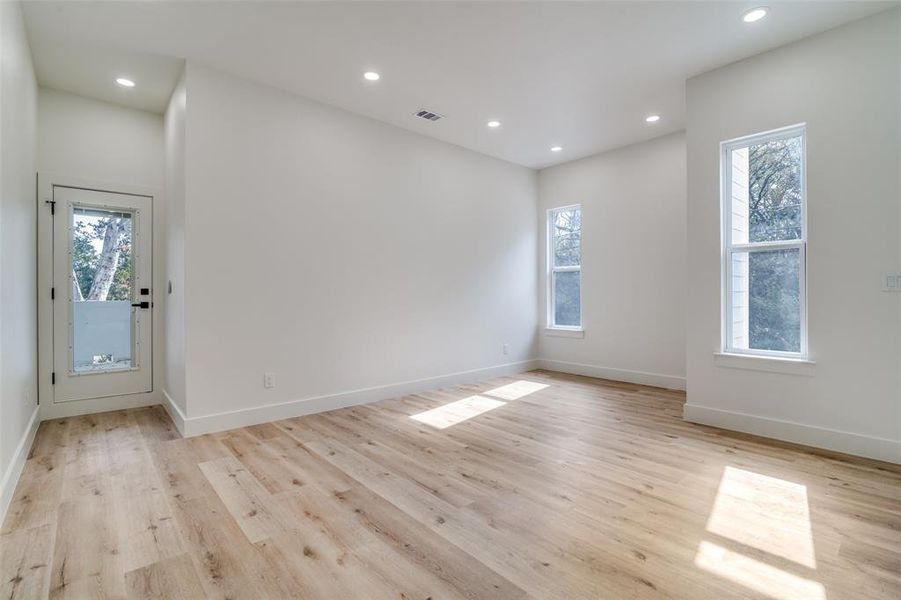 Empty room with recessed lighting and light wood finished floors
