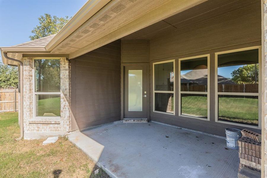 Property entrance with a patio area