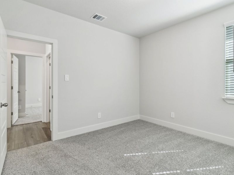 Guest bedroom in the San Saba floorplan at a Meritage Homes community.