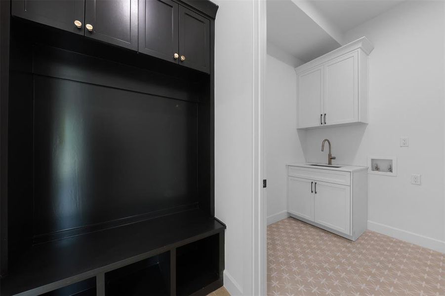 Mudroom with baseboards and a sink