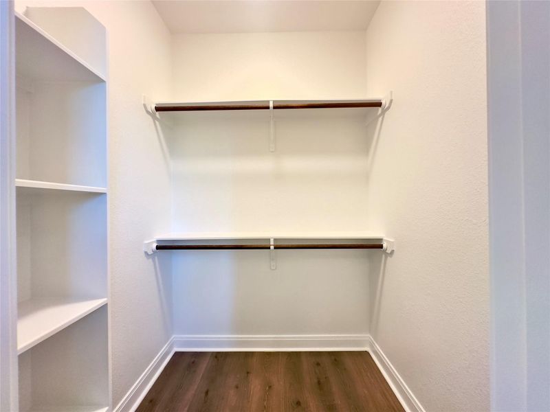 Walk in closet with LVP floors and shelves Walk in closet with LVP floors and shelves