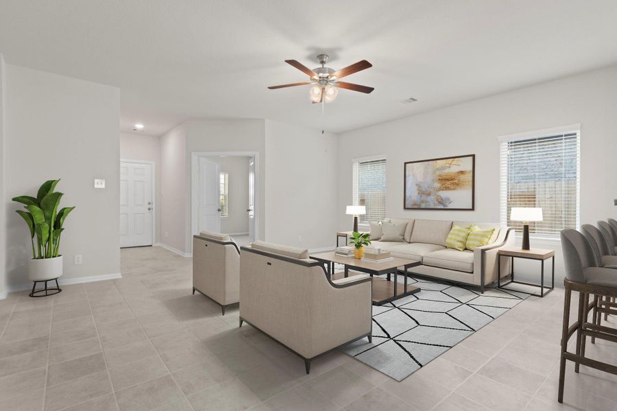Virtually staged to reflect everyday living, this open-concept view highlights the seamless connection between the entry, family, and kitchen areas. The combination of tile flooring and soft lighting creates an atmosphere that’s both stylish and welcoming.