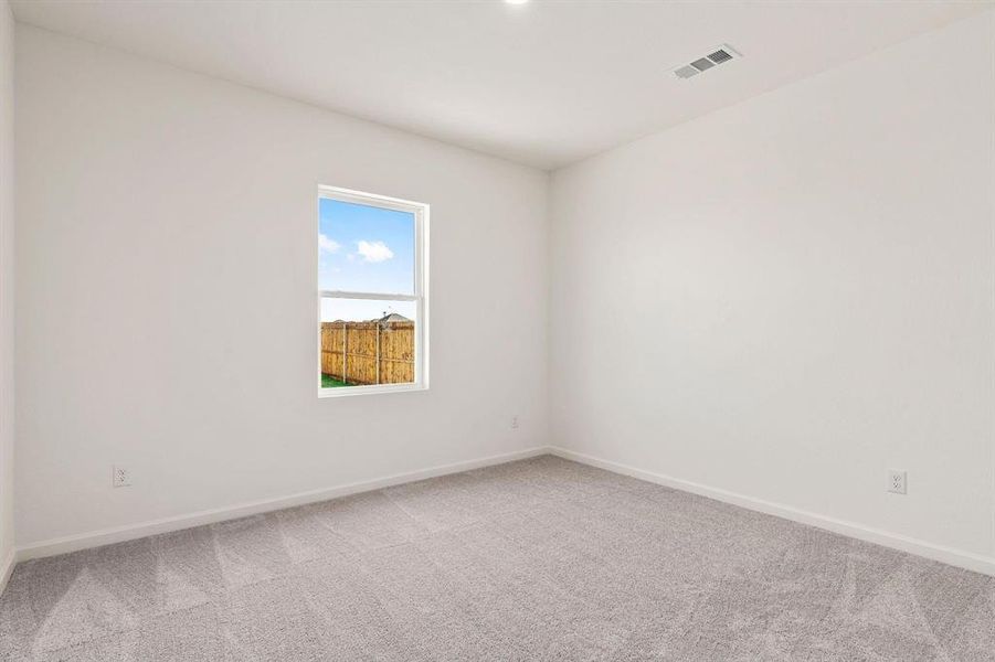 Spare room with carpet floors and baseboards Spare room with carpet floors and baseboards