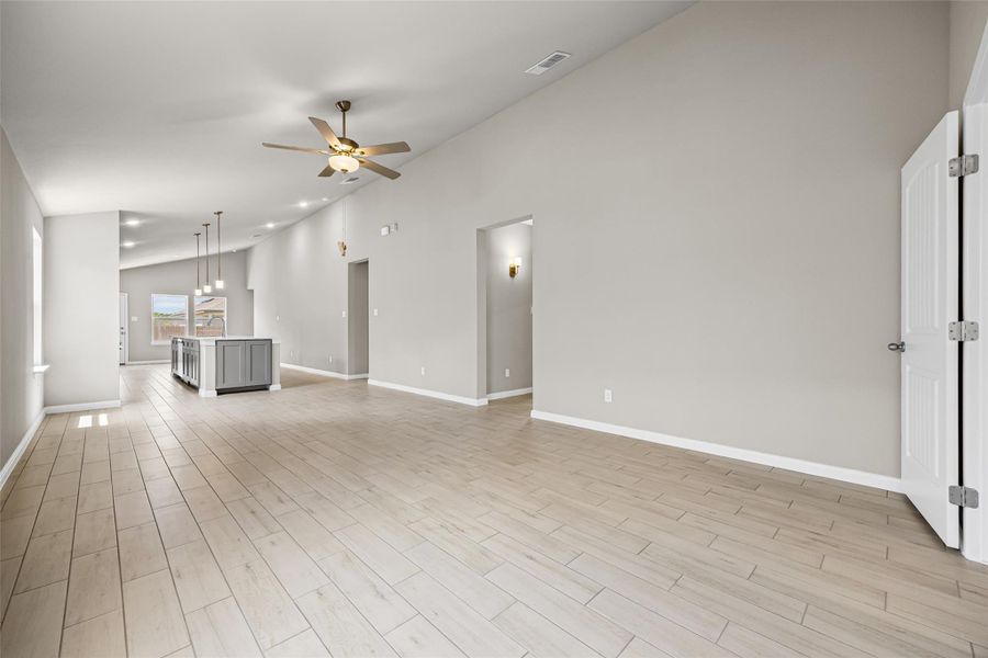 Vaulted ceilings and wood-look flooring enhance the open flow of this versatile living space. Vaulted ceilings and wood-look flooring enhance the open flow of this versatile living space.