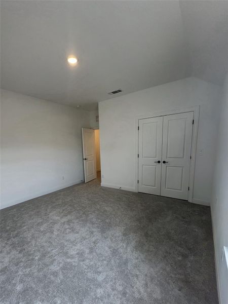 Room featuring gray patterned carpeting, white walls, and a recessed ceiling light Room featuring gray patterned carpeting, white walls, and a recessed ceiling light