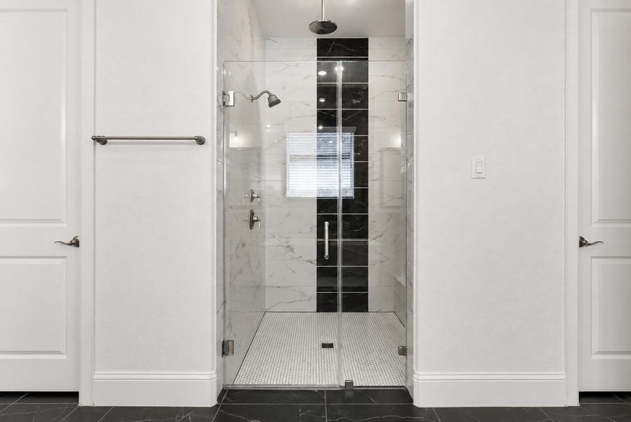 Another standout upgrade is the floor-to-ceiling tilework in every bathroom shower.