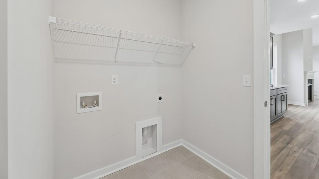 Dedicated laundry room with ventilated shelf