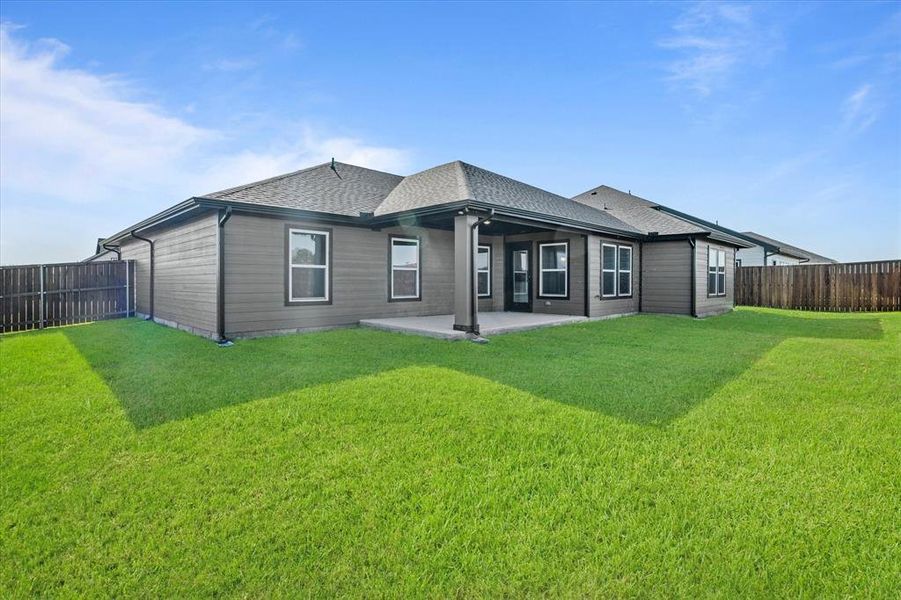 Rear view of property with a patio area and a lawn