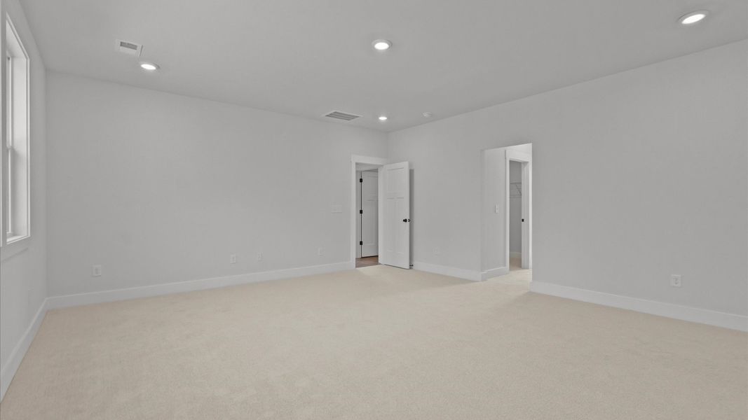 Exclusive upstairs retreat with a bright and airy primary suite with a walk-in closet