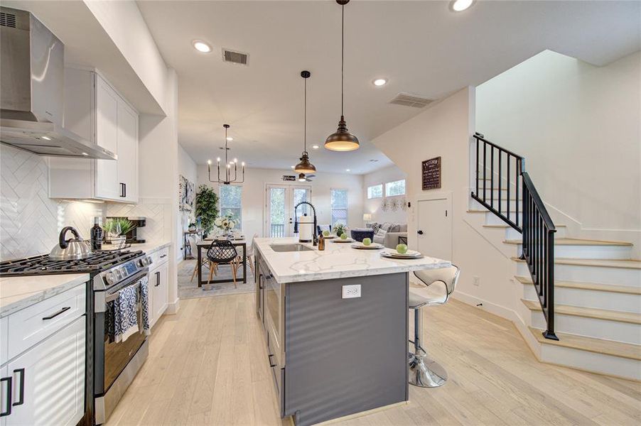 Gourmet kitchen features soft closing shaker style cabinetry and stainless steel LG smart appliances.