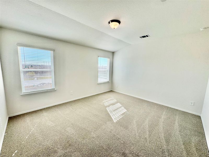Carpeted empty room featuring baseboards and a textured ceiling