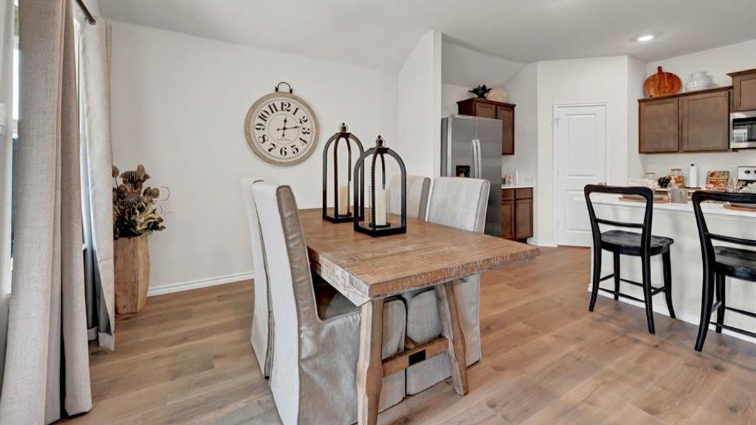 Dining space with light wood-style flooring and recessed lighting