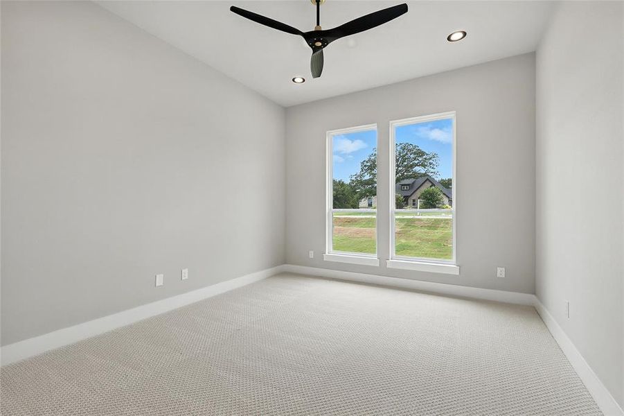 Empty room with light colored carpet, ceiling fan, and recessed lighting