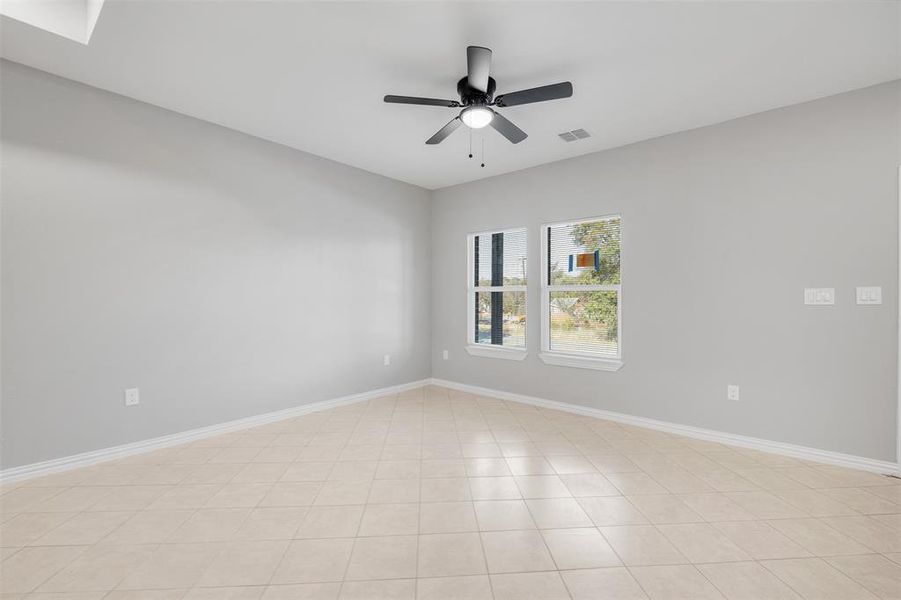 Tiled spare room with ceiling fan