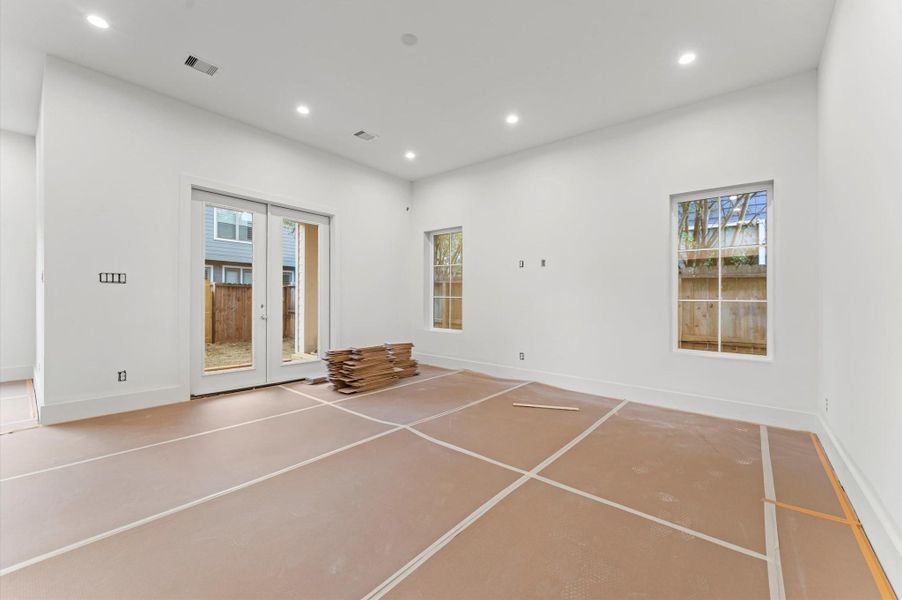 Spacious living area with doors leading to the covered patio.