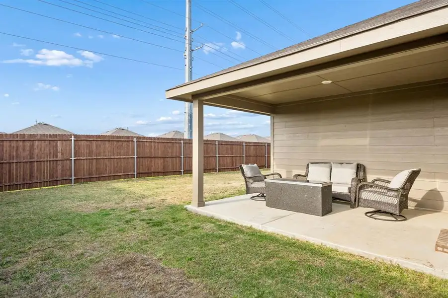 Fenced backyard with a patio and outdoor furniture Fenced backyard with a patio and outdoor furniture